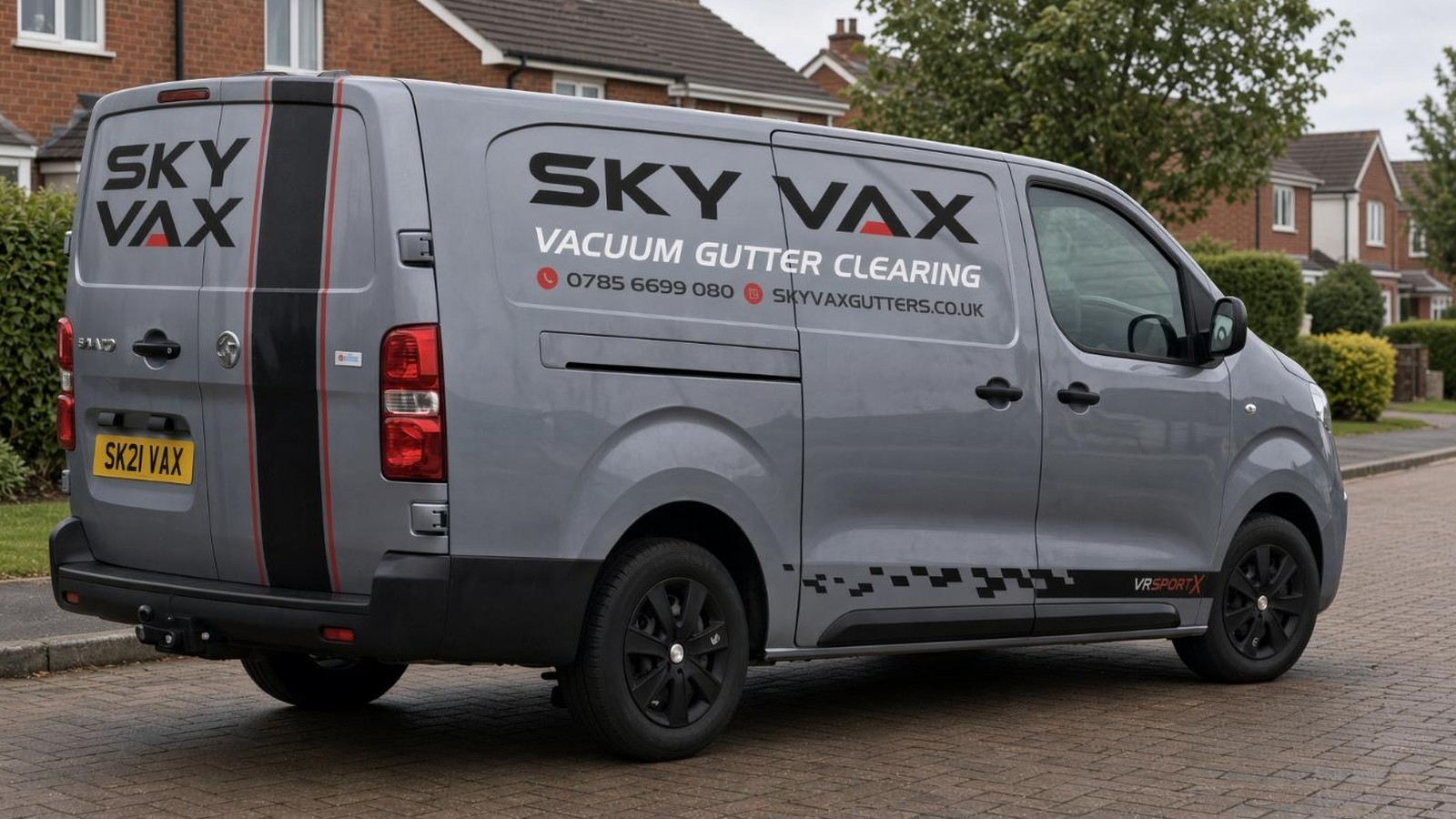 Sky Vax grey van with SKY VAX livery, parked on a street in Carrickfergus.